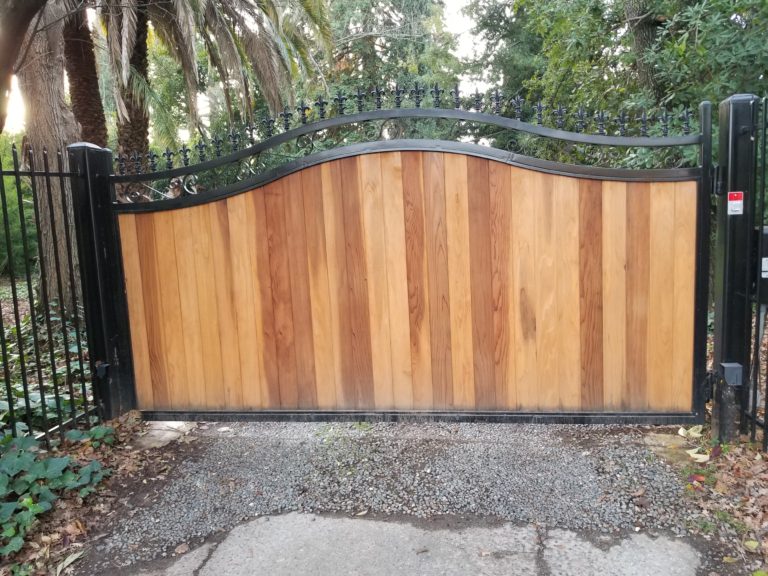 A wrought iron gate with wood in the middle